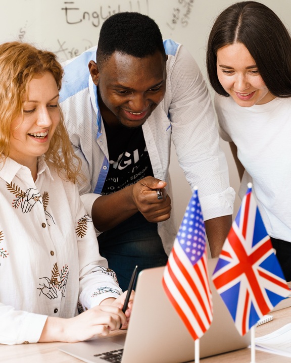 Multiethnic happy students and black teacher study foreign languages and smile and laught together in class. Studing with laptop. Black handsome student study with white people together.