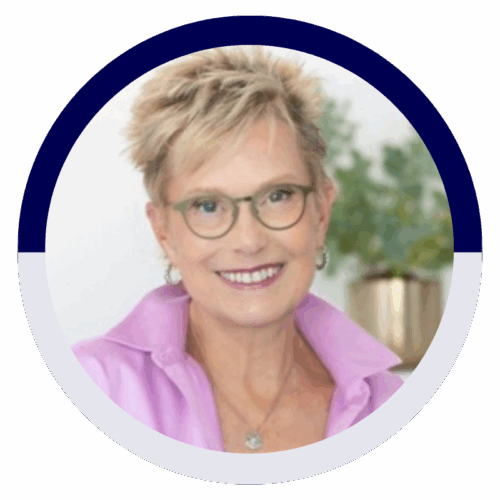 Headshot of a smiling woman with short blonde hair, glasses, and a pink collared shirt.