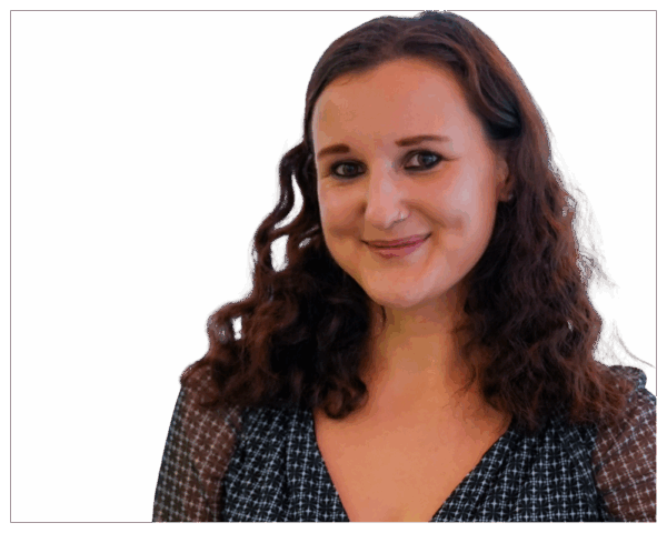 Smiling woman with curly brown hair wearing patterned top