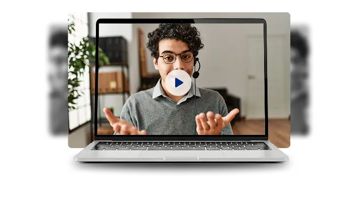 A man presents a laptop showing a video, engaged with the content as he looks at the screen.